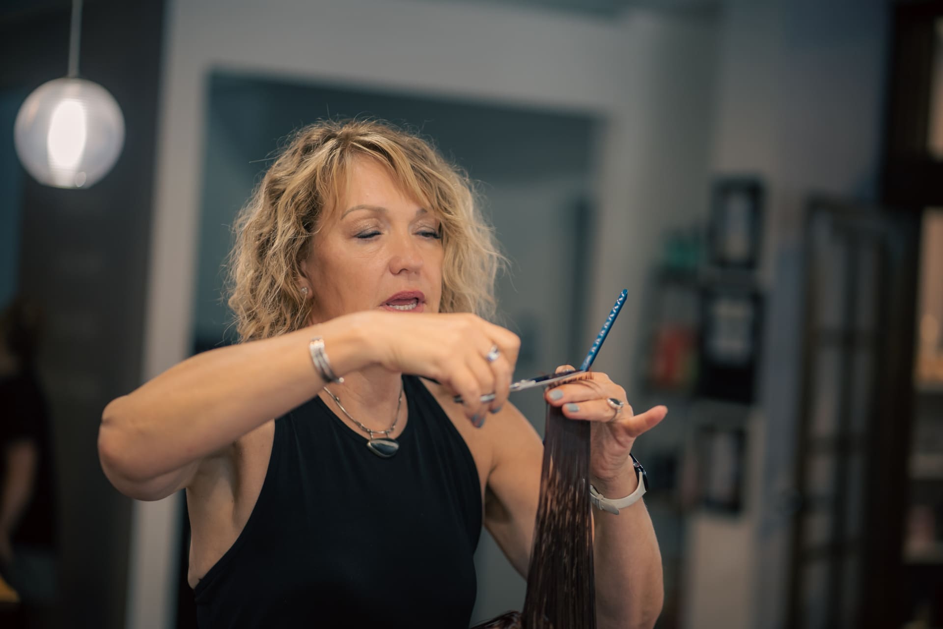 Stylist cutting hair at Studio 16 Salon & Spa